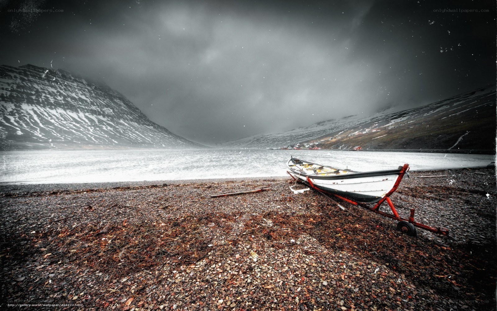 Abandoned boat on a pebble beach