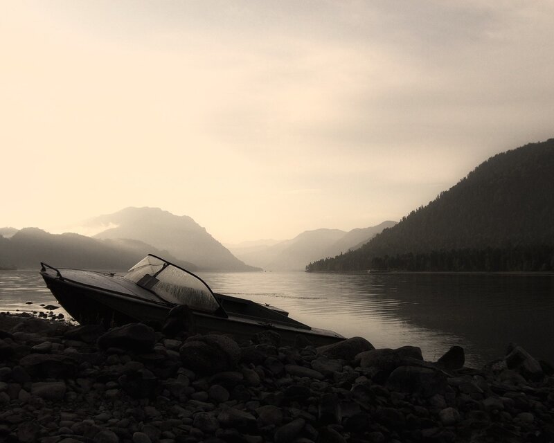 abandoned boat on a rocky shore