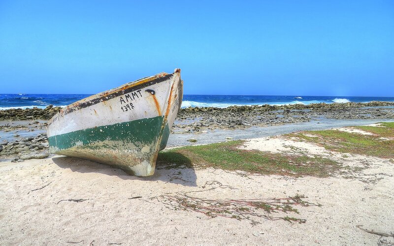 Abandoned Boat on Beach — Blue, Serene, Afternoon, Photograph, Ocean