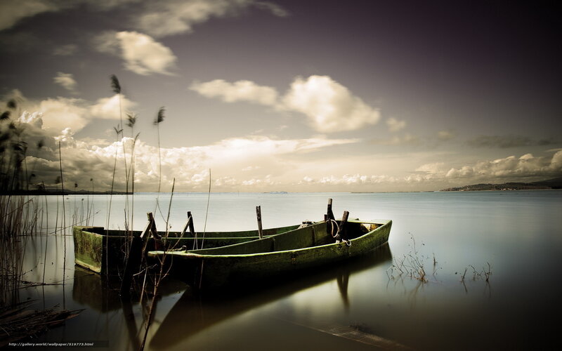 Abandoned boat on calm lake