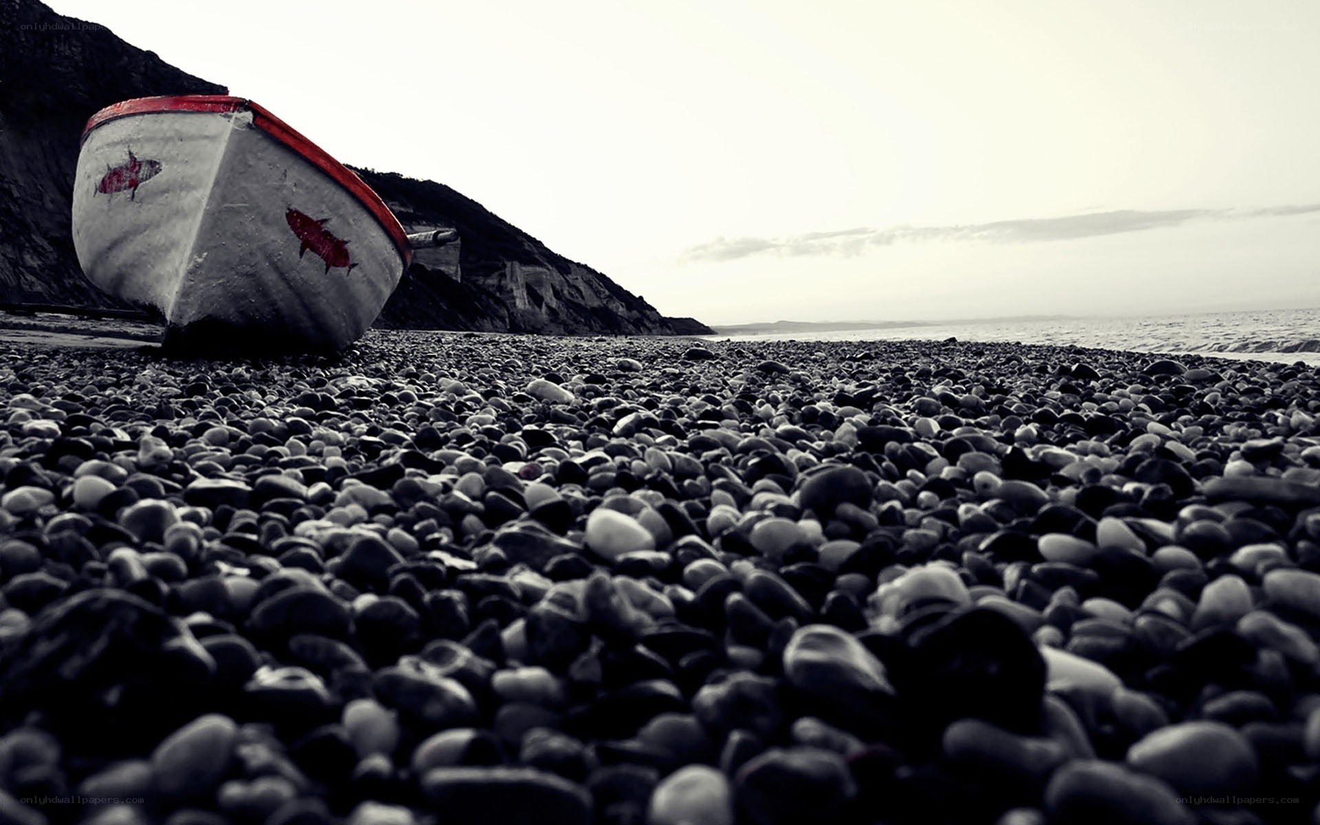Abandoned boat on pebble beach