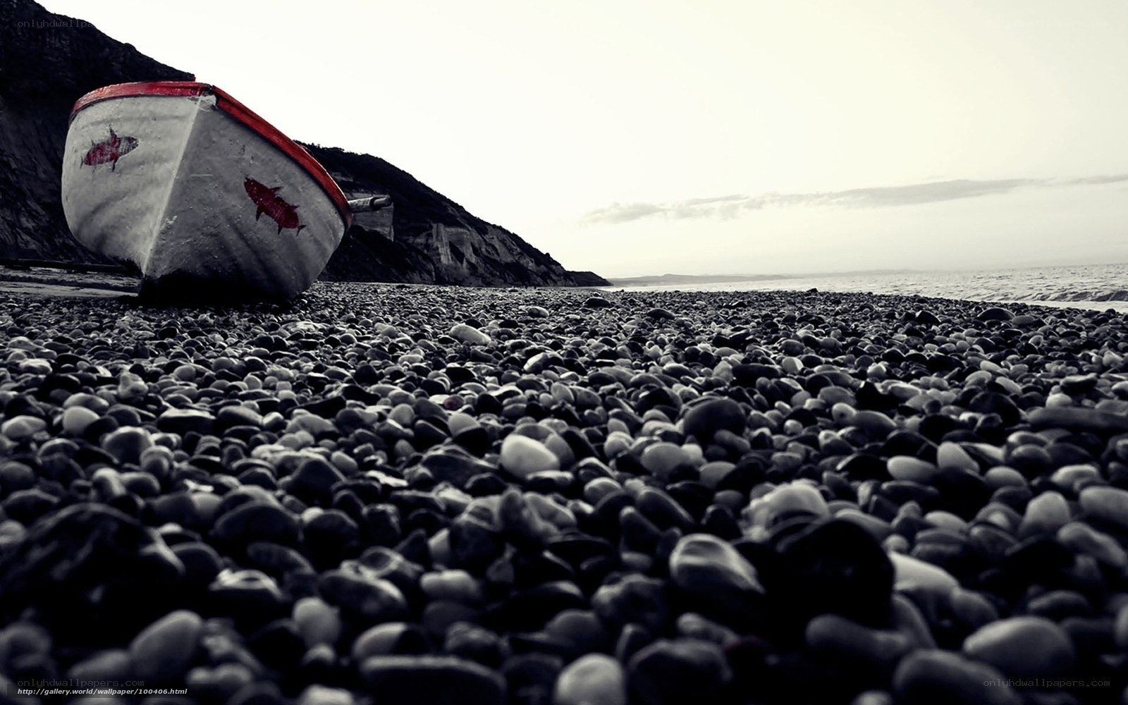 Abandoned boat on pebble beach