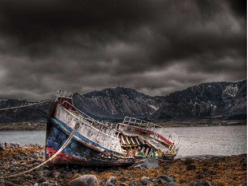 Abandoned boat on rocky shore