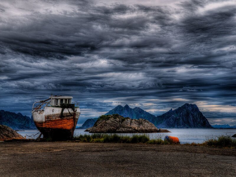 Abandoned boat on rocky shore