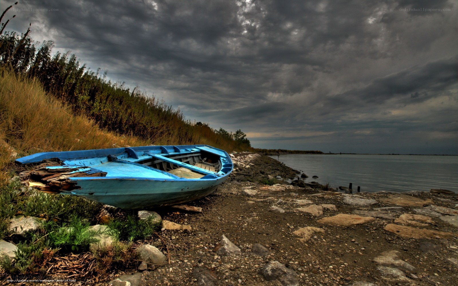 Abandoned boat on rocky shore