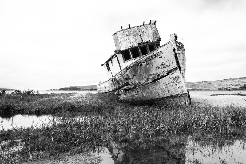 Abandoned Boat on Shore — Black, Desolate