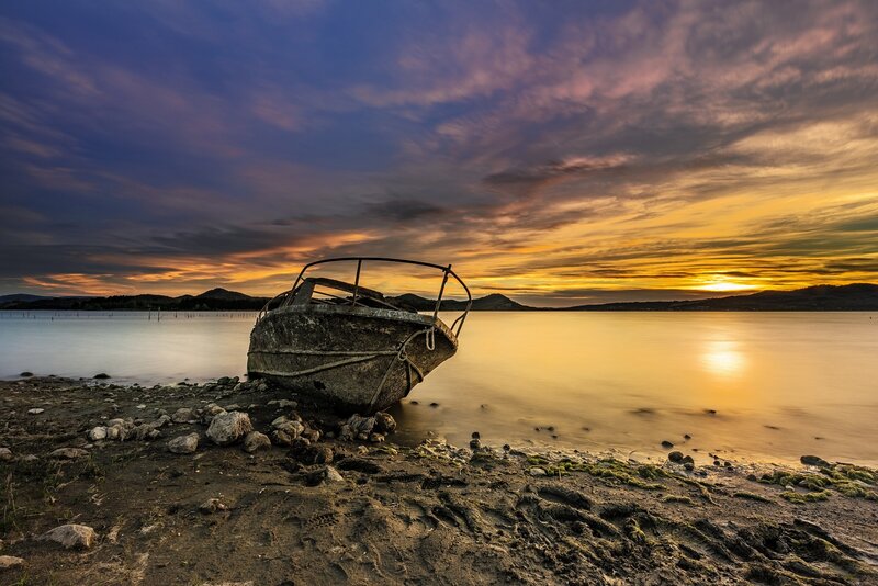 Abandoned Boat on Shore — Blue, Dramatic, Sunset, Photograph