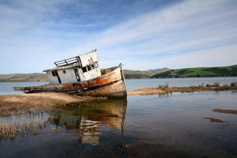 Abandoned Boat on Shore — Blue, Serene, Afternoon, Photograph, Water