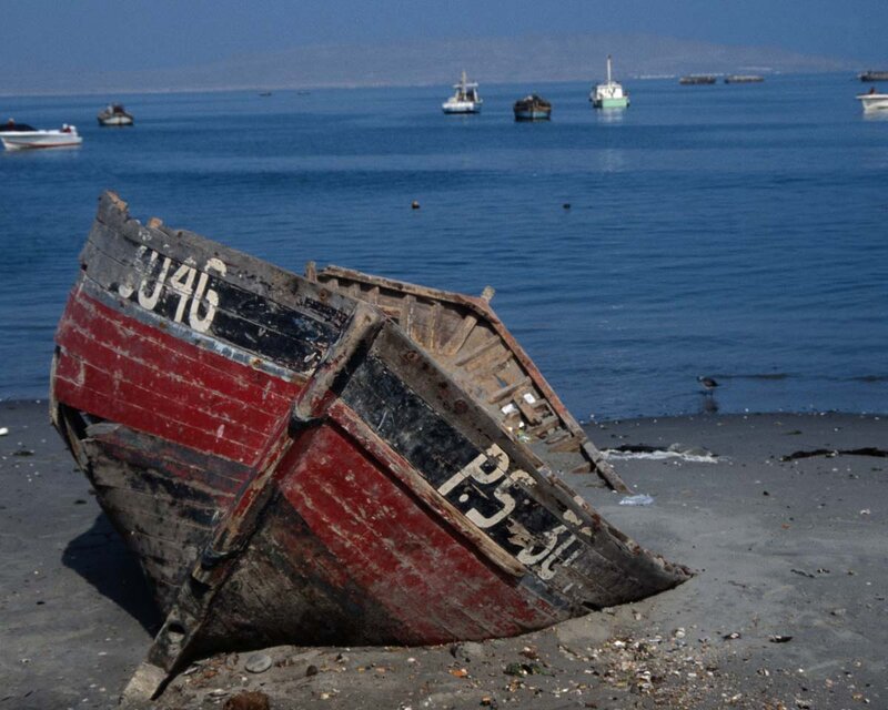 Abandoned Boat on Shore — Blue, Serene, Afternoon