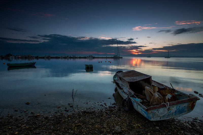 Abandoned Boat on Shore — Blue, Serene, Sunset
