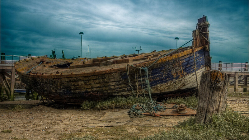abandoned boat on shore