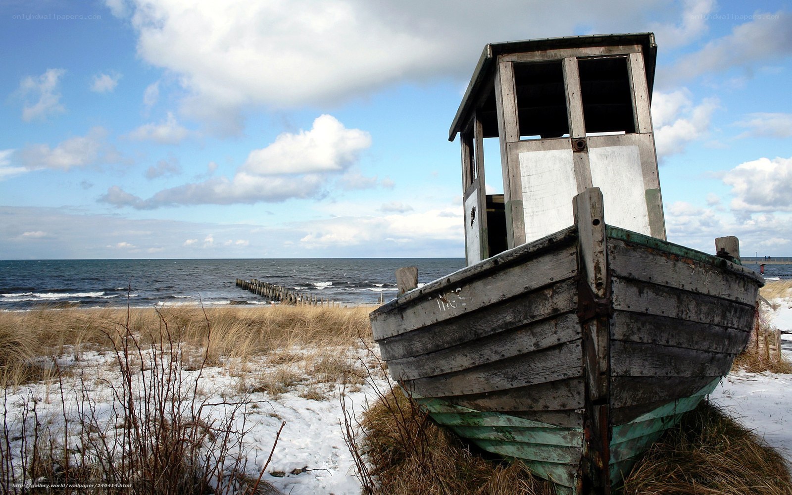 abandoned boat on snowy shore