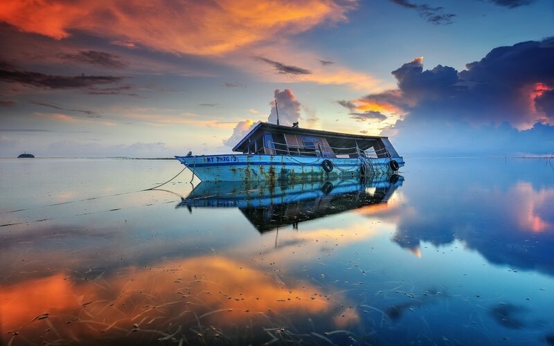 Abandoned Boat on Water — Blue