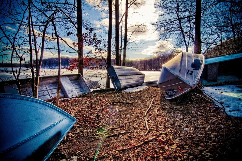 Abandoned boats by a frozen lake