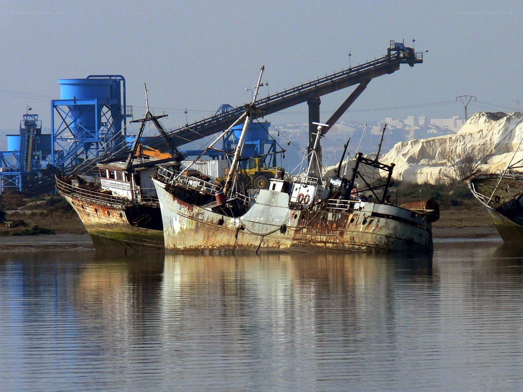 Abandoned boats in a harbor