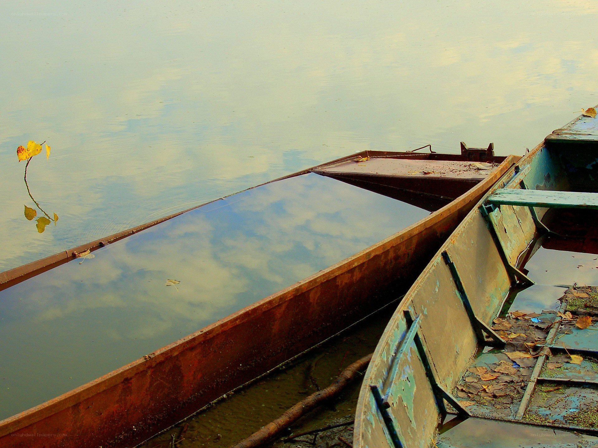 abandoned boats on a calm lake