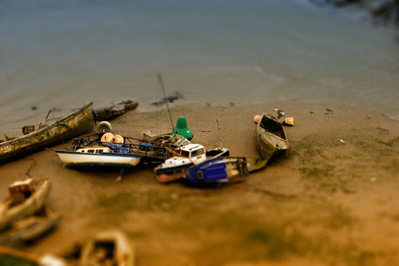 abandoned boats on a muddy shore