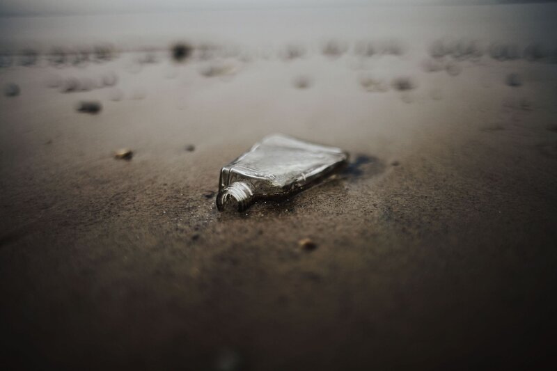 abandoned bottle on beach