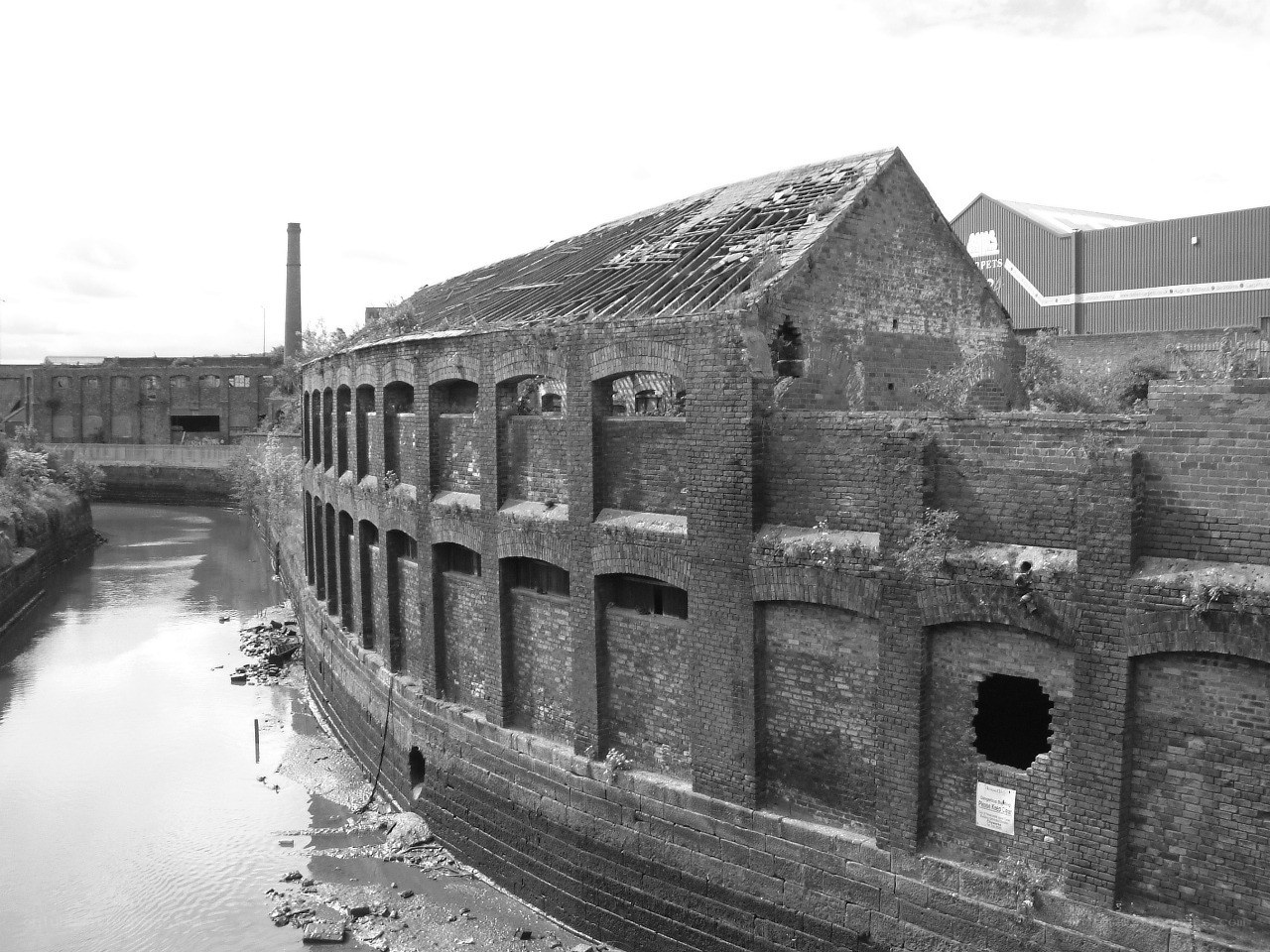 abandoned brick building by canal