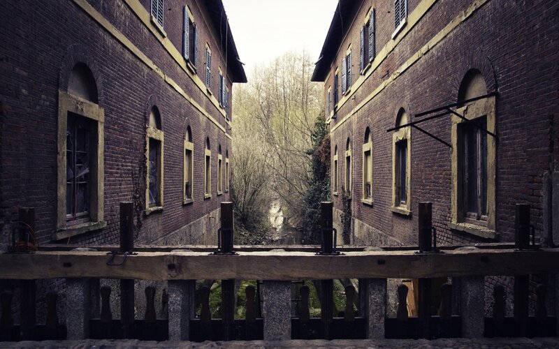 abandoned brick buildings by canal