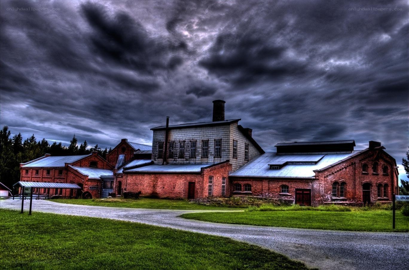 Abandoned brick factory under stormy sky
