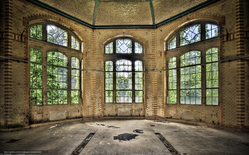 Abandoned brick hall with arched windows