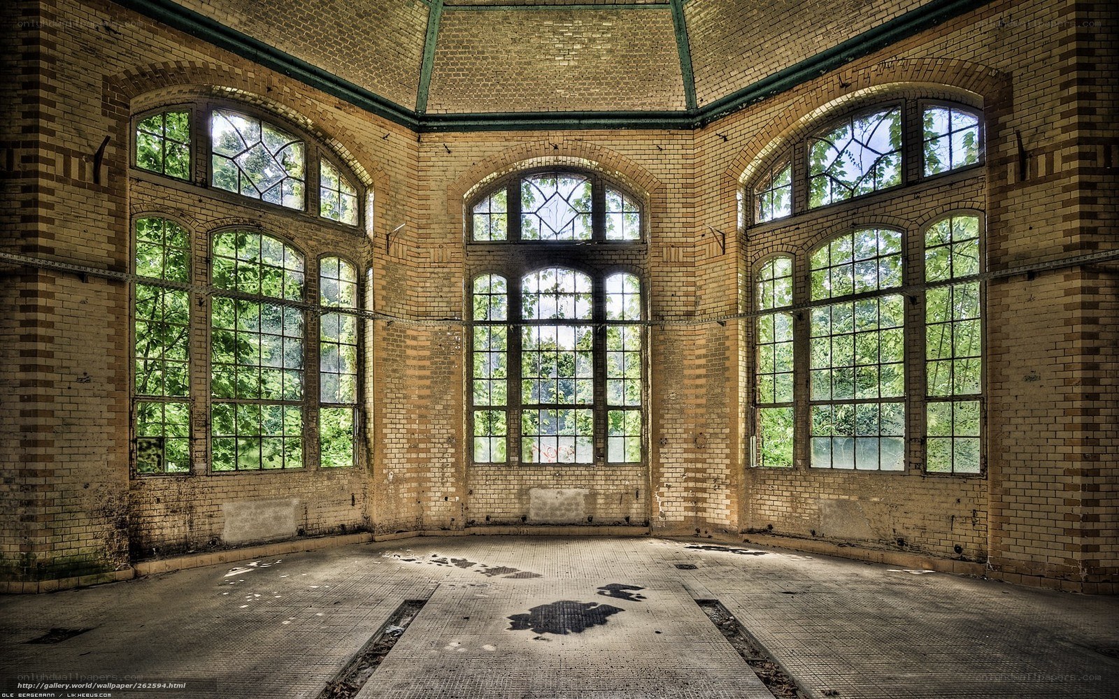 Abandoned brick hall with arched windows