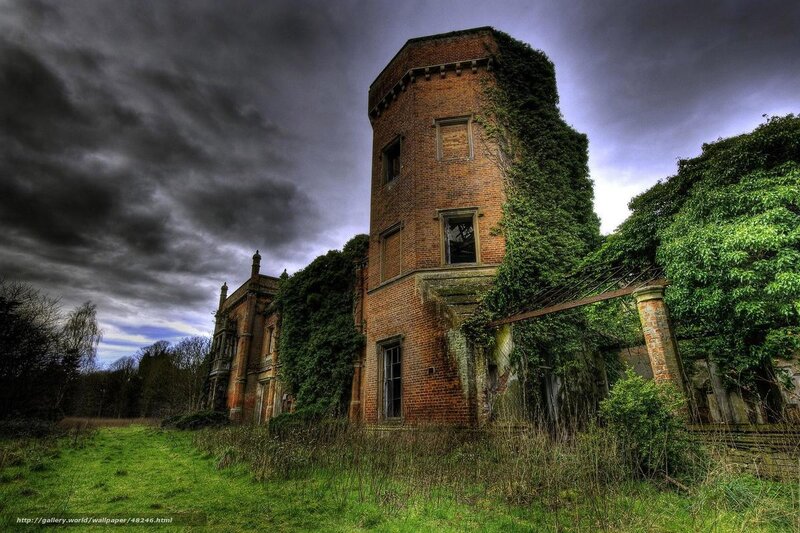 Abandoned brick tower in overgrown landscape
