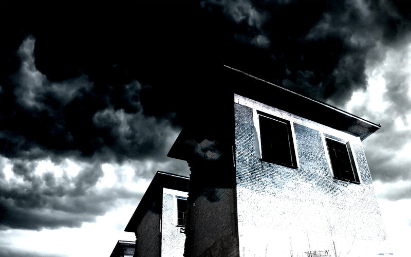 abandoned building under stormy sky
