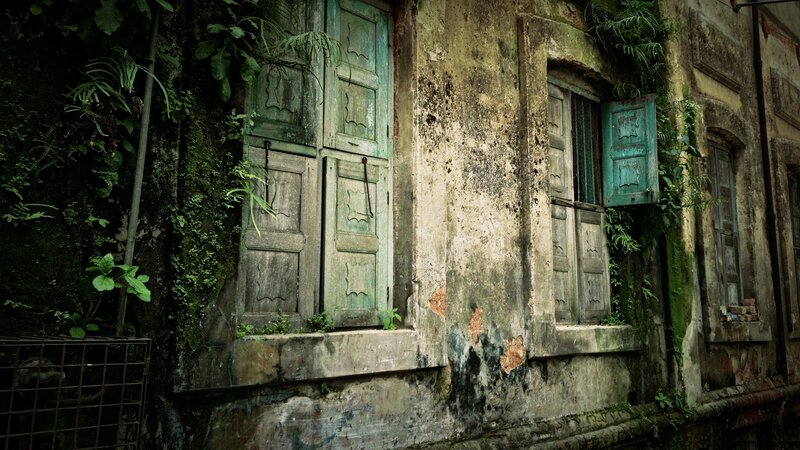abandoned building with green doors