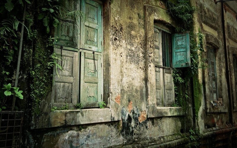 abandoned building with green shutters