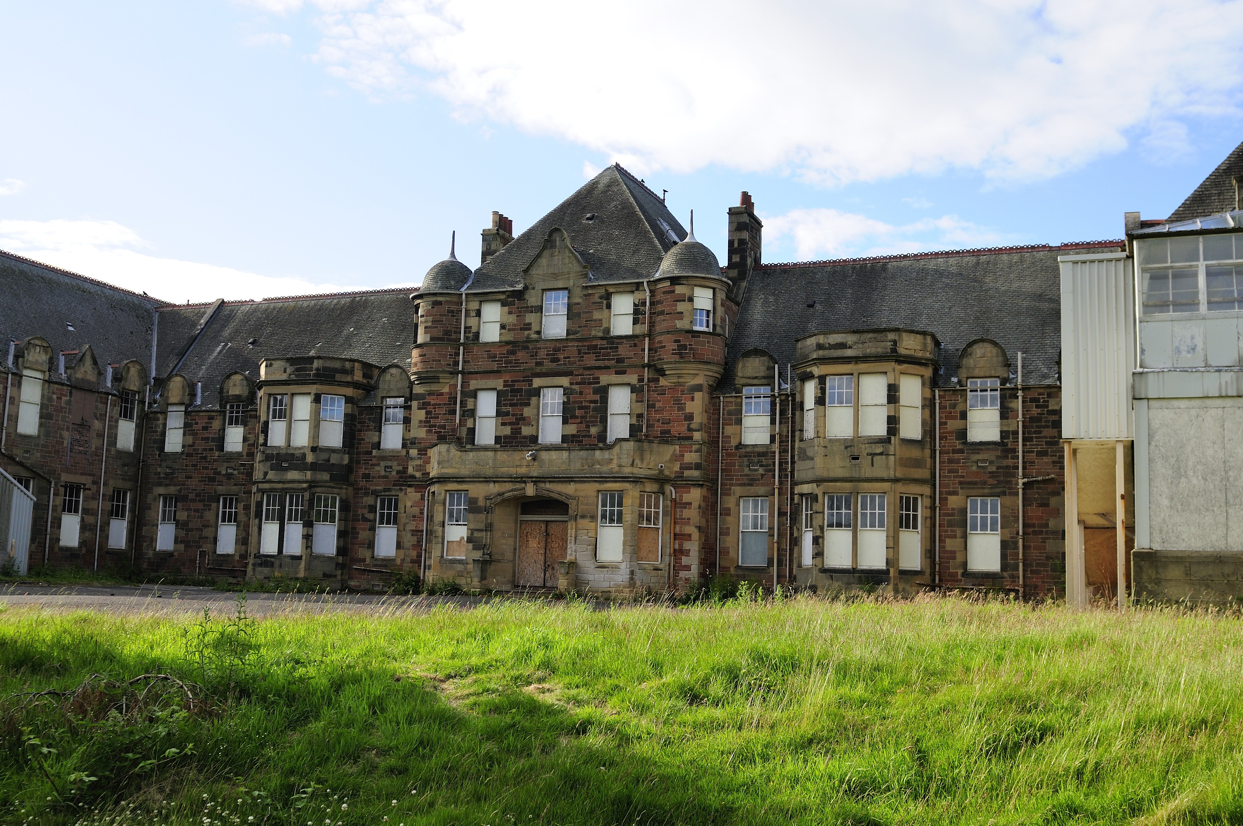 Abandoned building with overgrown grass