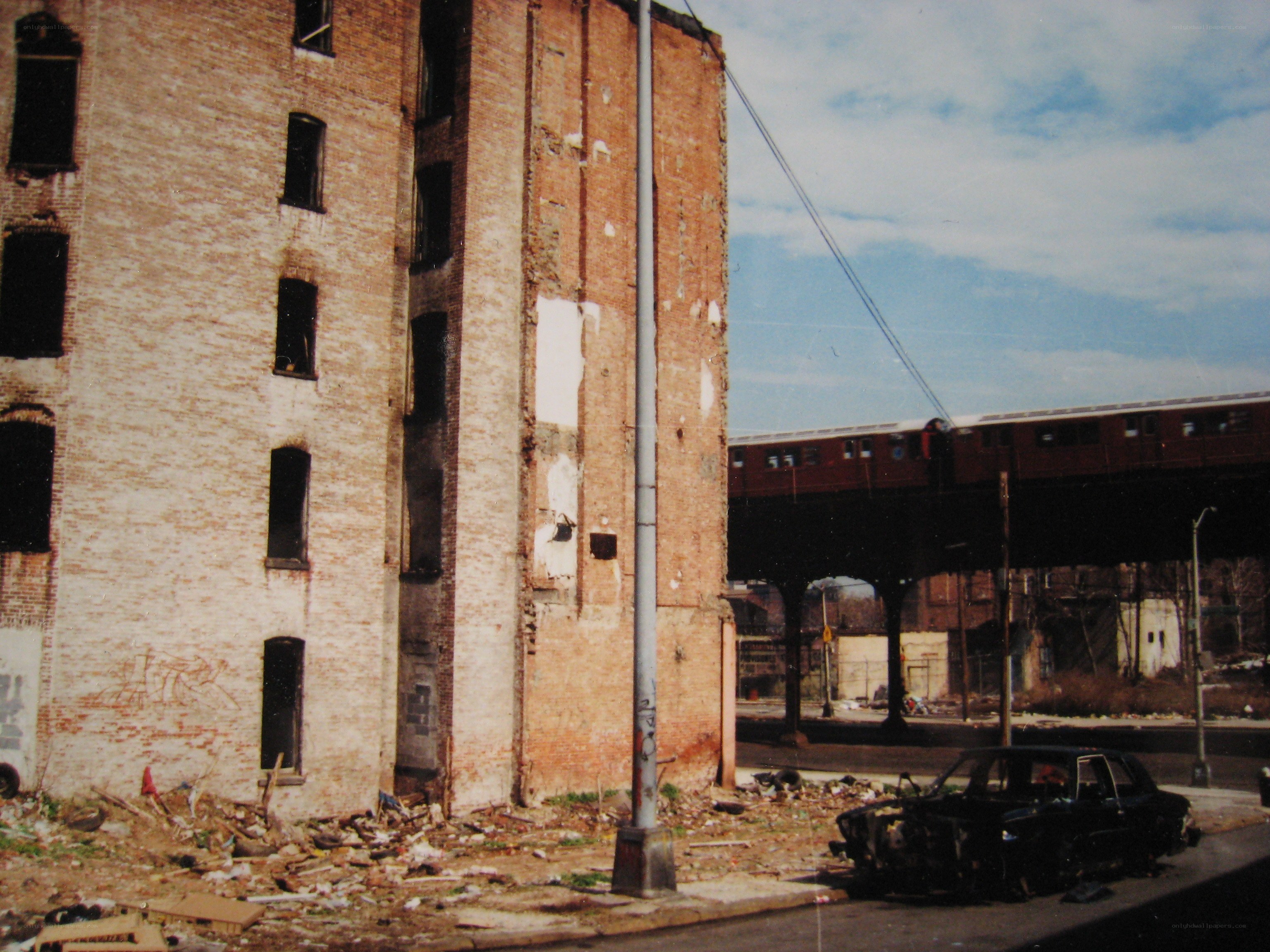 Abandoned building with train overpass