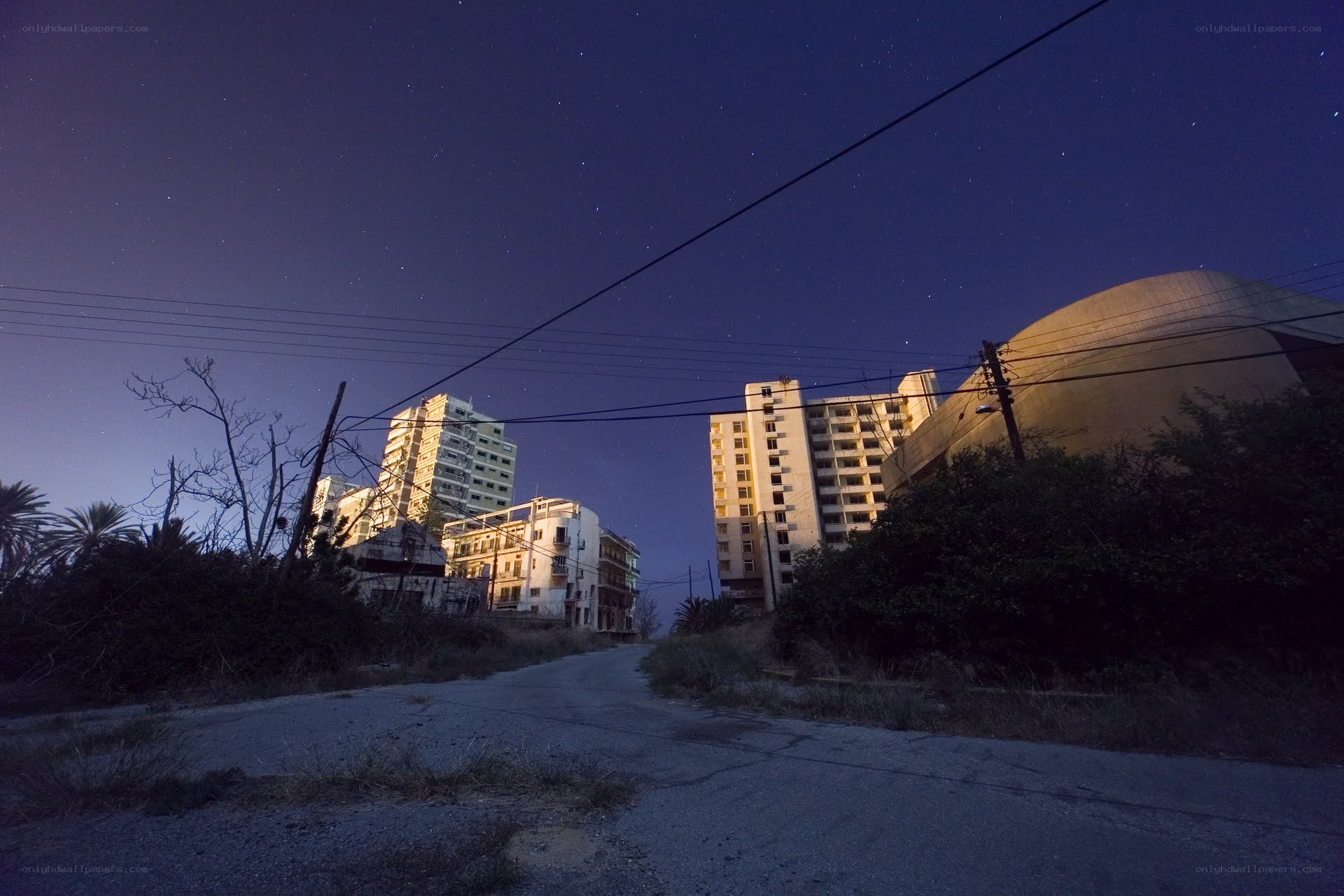 Abandoned buildings under starry sky