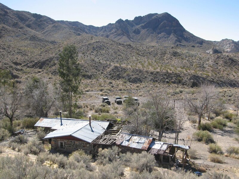 Abandoned cabin in desert valley