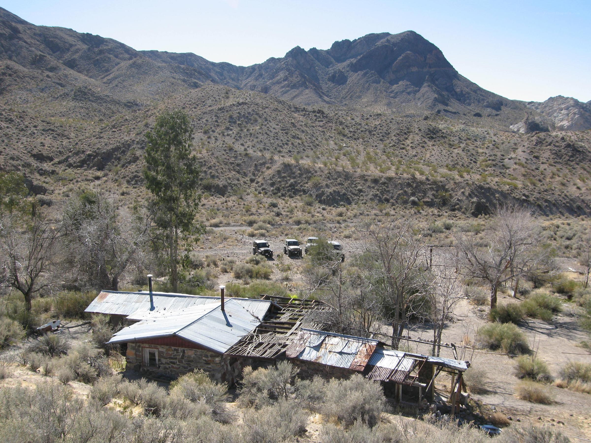 Abandoned cabin in desert valley