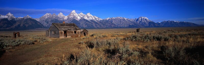 Abandoned Cabin in Field — Blue, Serene, Afternoon, Photograph, Mountains, Brown, White