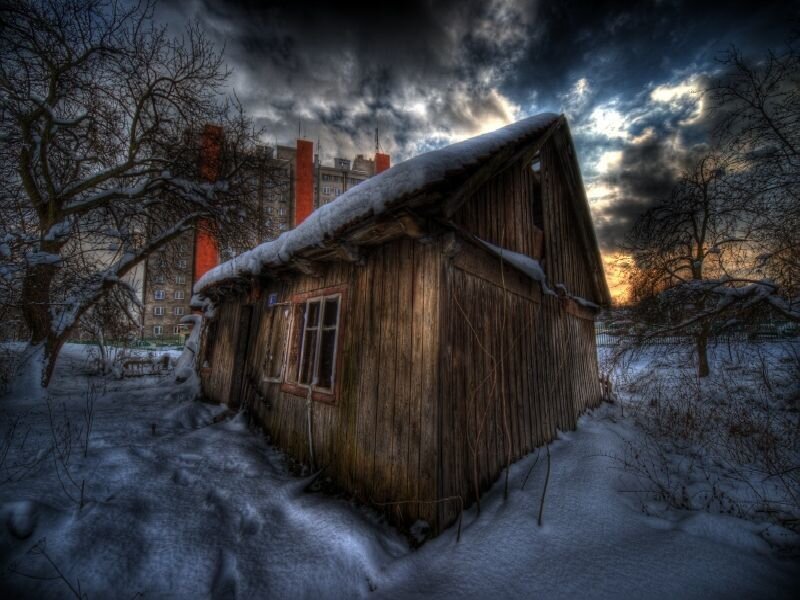 Abandoned cabin in snowy landscape