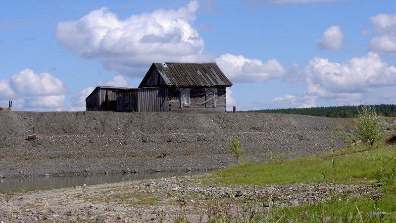 Abandoned cabin on a gravel mound