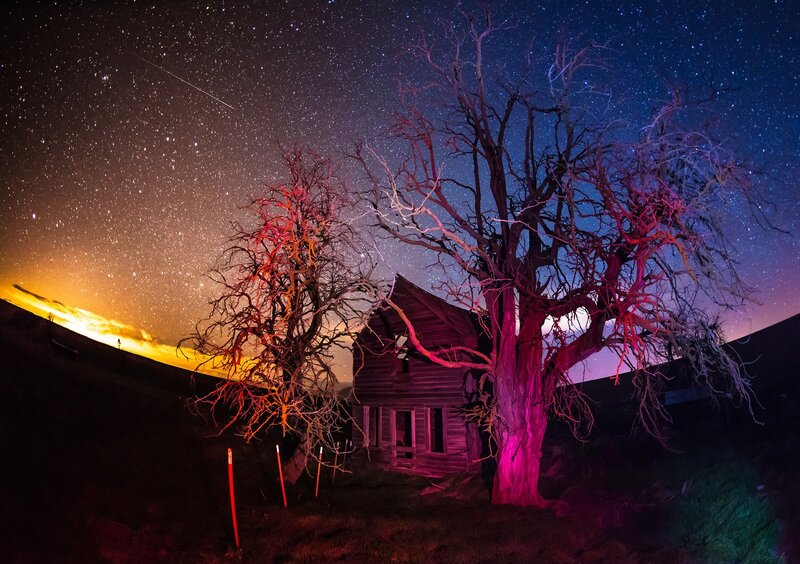 Abandoned cabin under starry sky