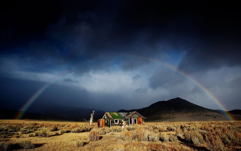 Abandoned cabin with rainbow