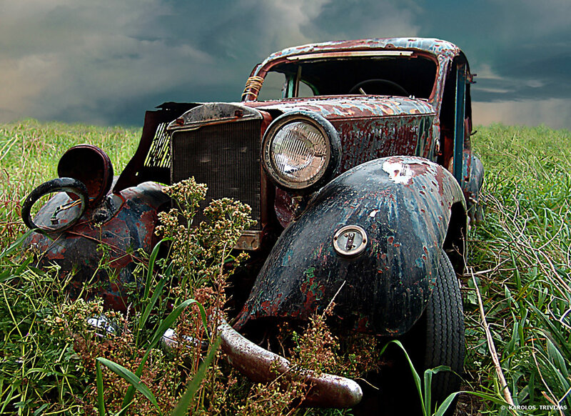 abandoned car in a field