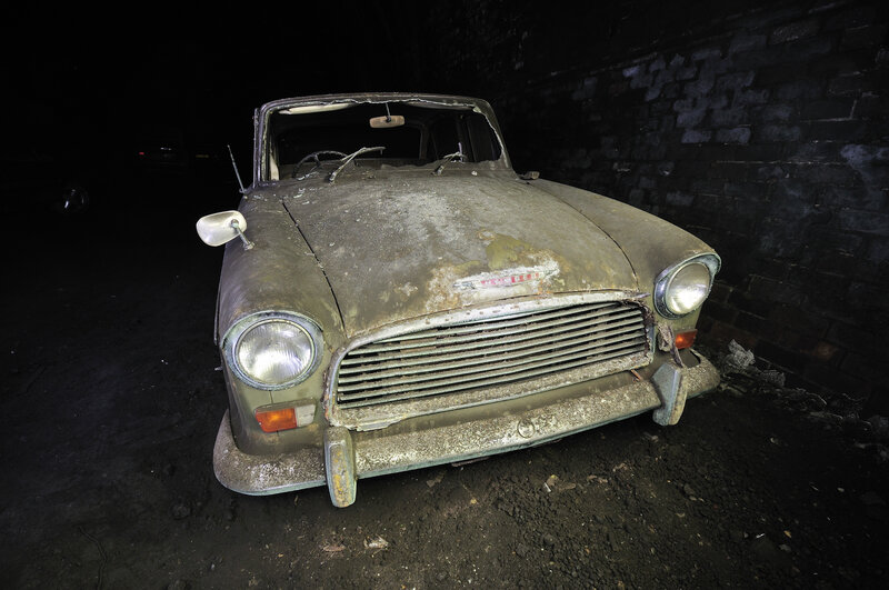 Abandoned car in dark tunnel