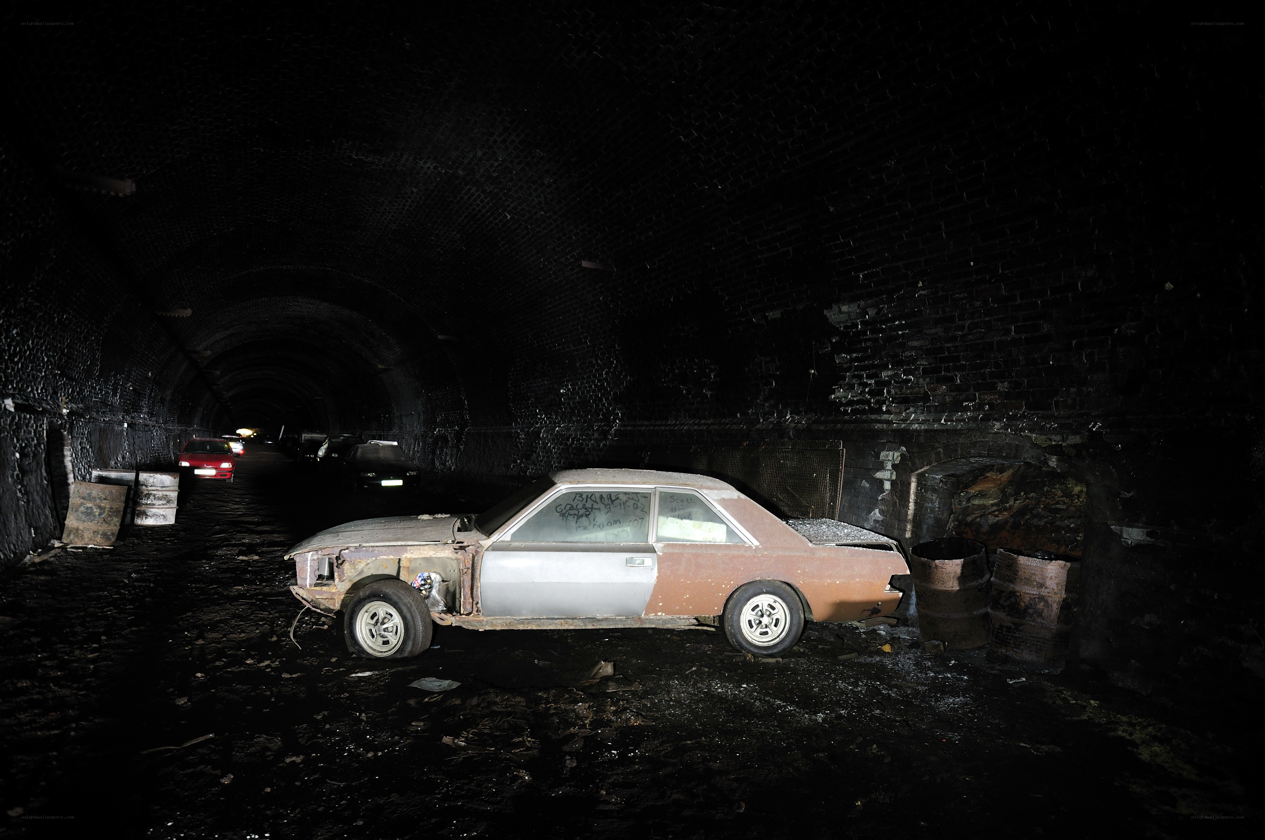 Abandoned car in dark tunnel