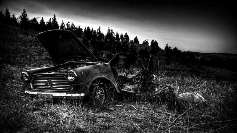 abandoned car in field