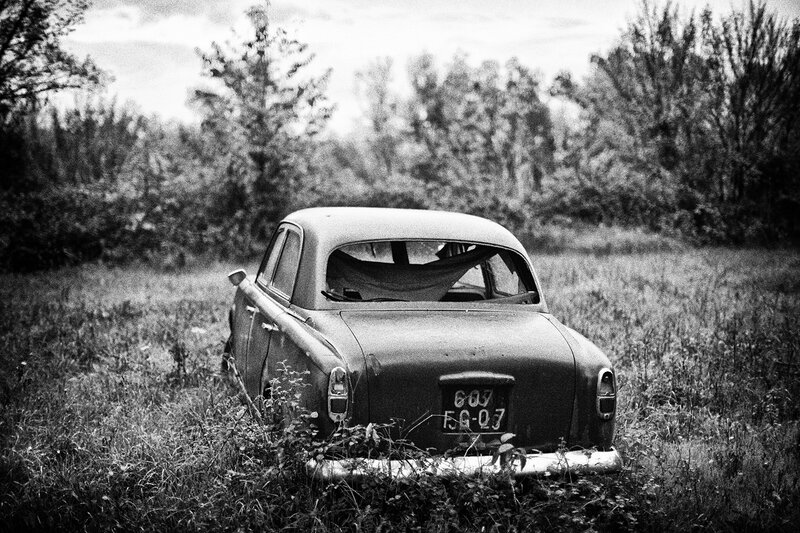Abandoned Car in Field — Black, Desolate, Photograph