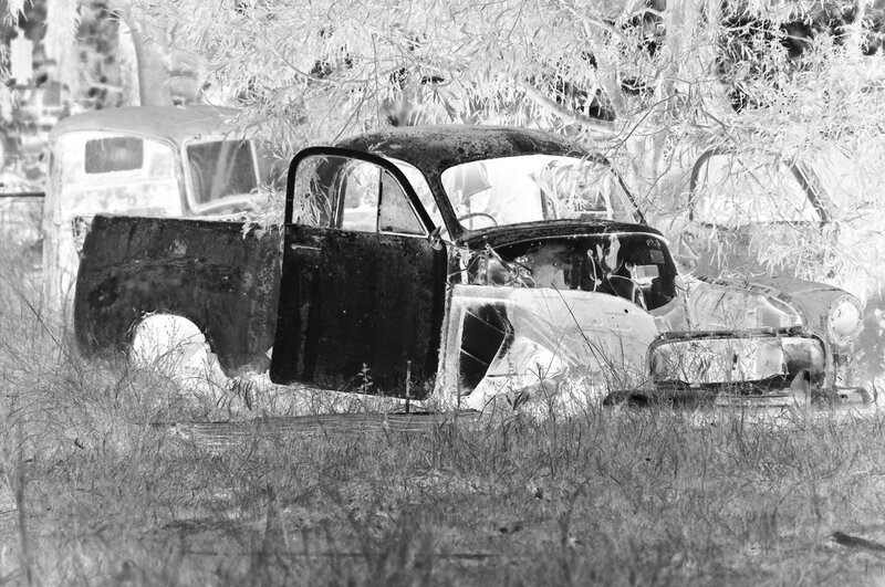 Abandoned Car in Field — Black, Desolate