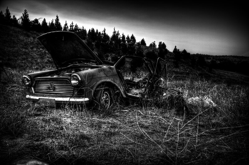 abandoned car in field