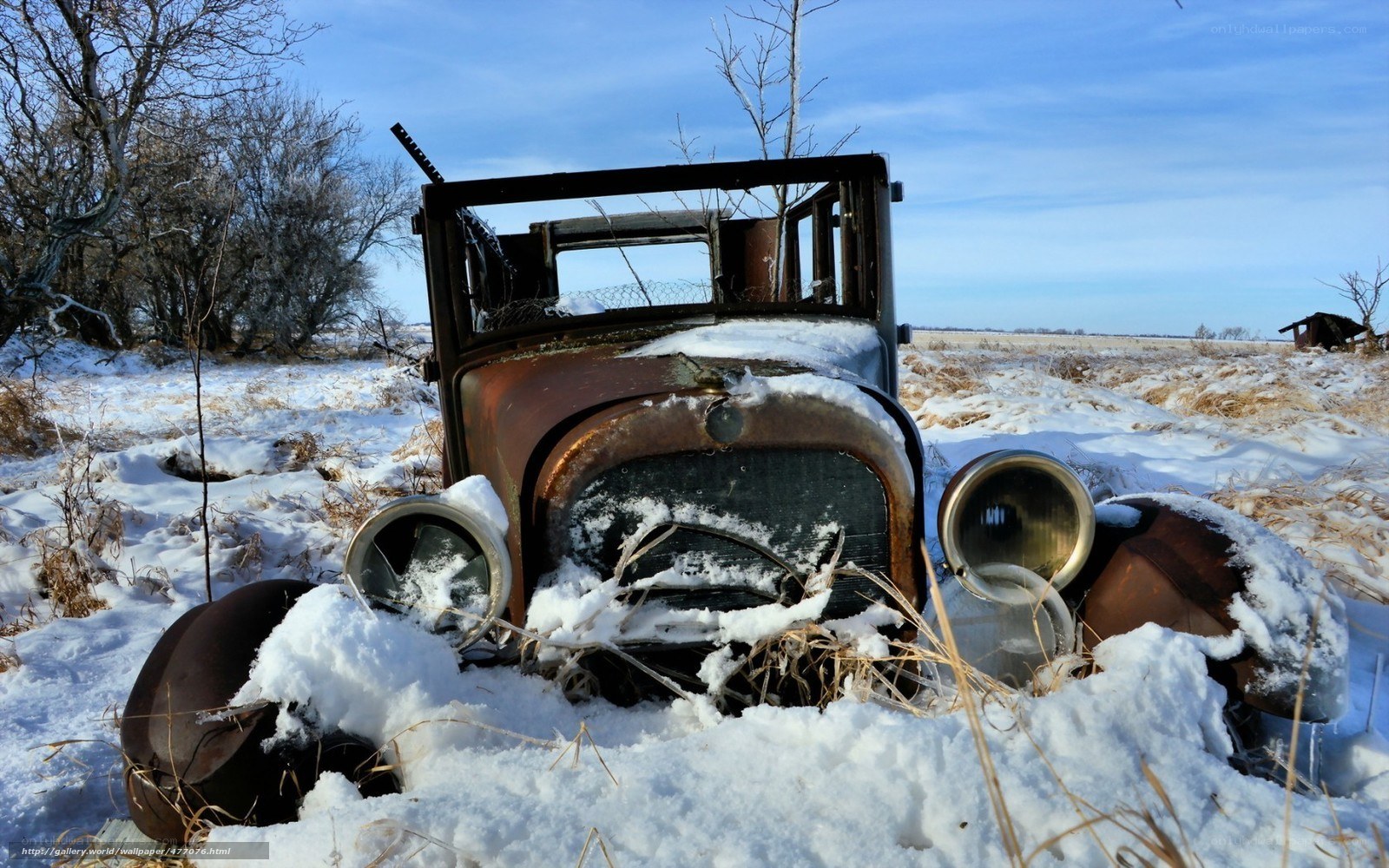 Abandoned car in snowy field