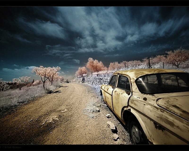 Abandoned car on a dirt road